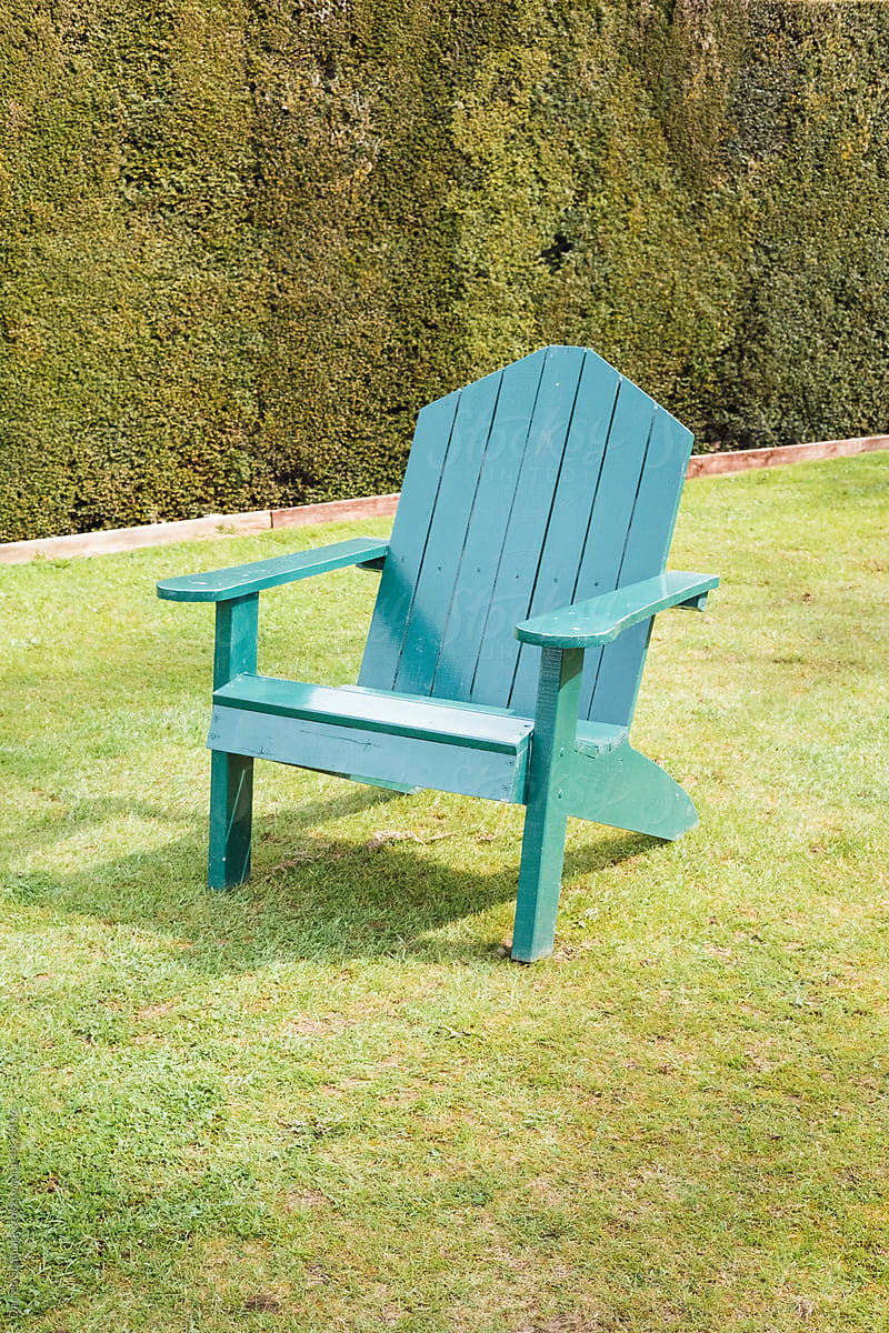 Green wooden chair in a garden