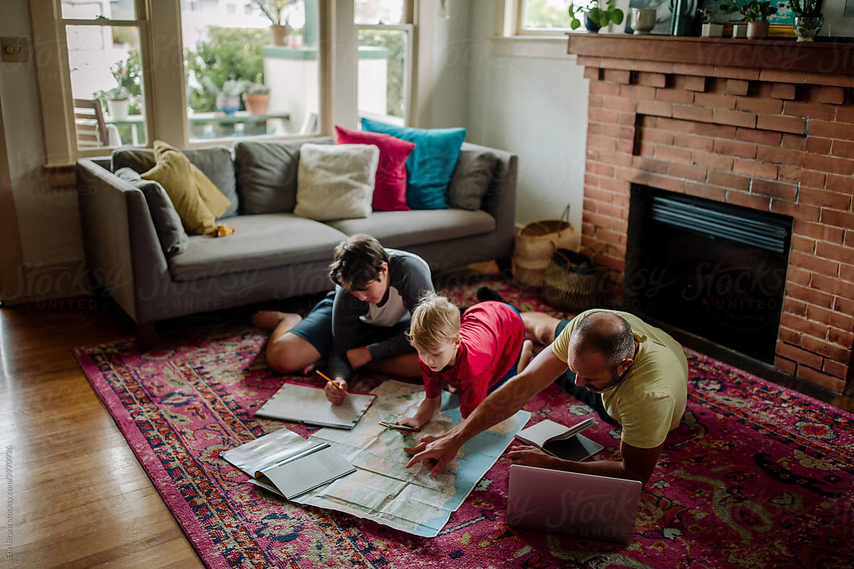 Father and boys studying map