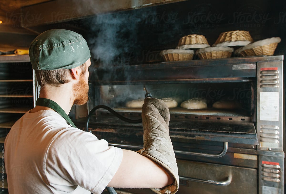 Baker Posing With His Freshly-baked Bread At A Small-scale, Artisan Bakery  by Stocksy Contributor Misha Dumov - Stocksy