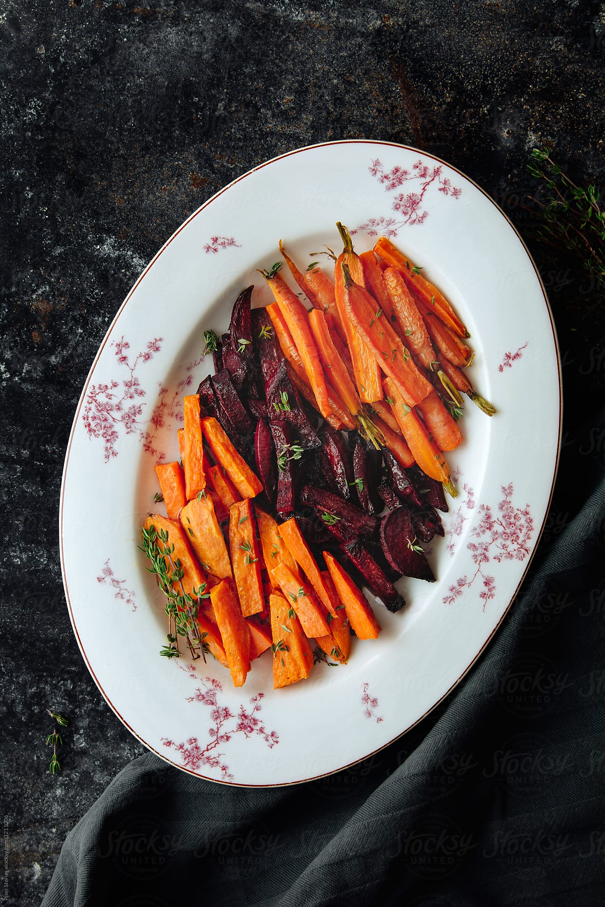 Baked sweet potatoes, beet and carrots with thyme salad