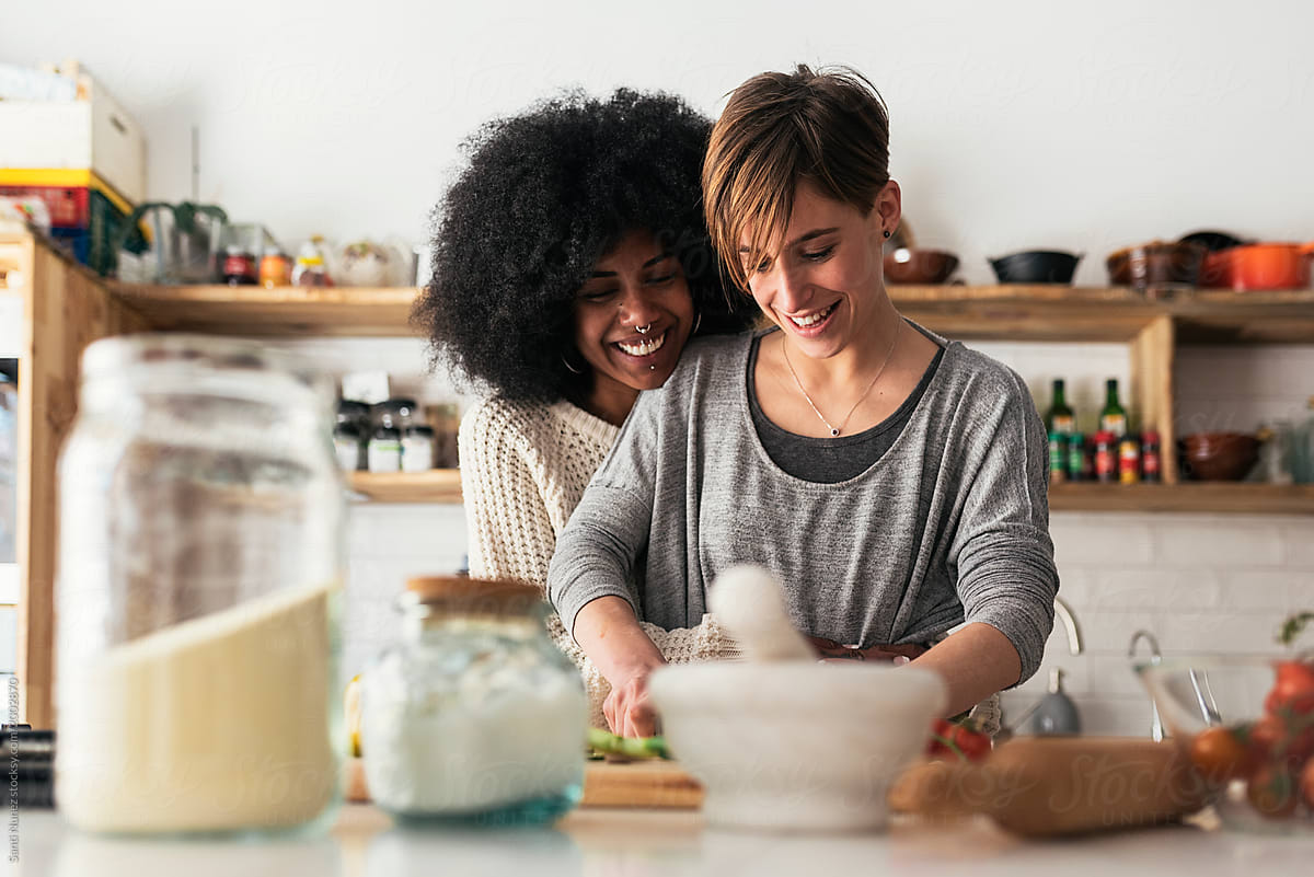 Two Beautiful Girls Cooking In Them Home By Stocksy Contributor Santi Nuñez Stocksy 