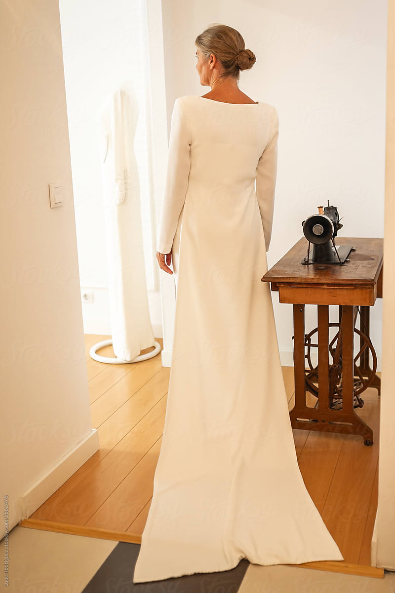 mature woman trying on her wedding dress