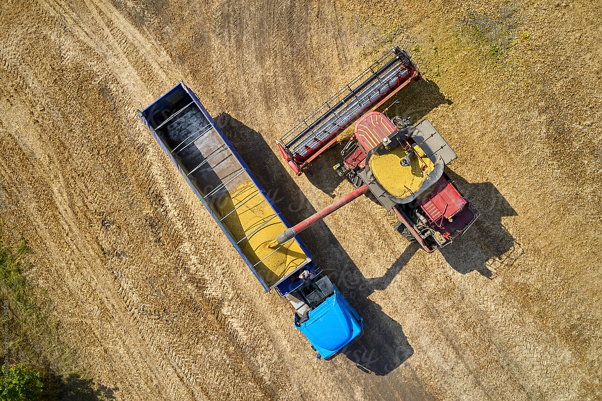 View from above at field with combine and truck