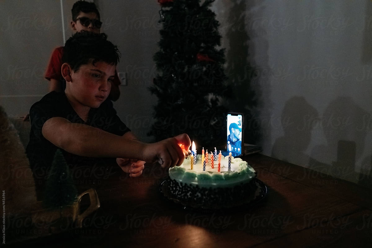 Lighting candles on a birthday cake.