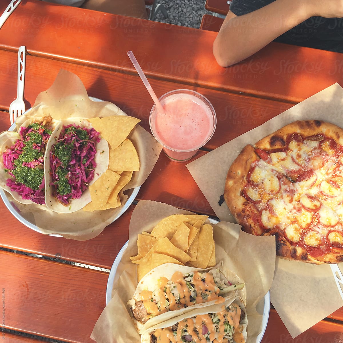 An Assortment of Tacos And Pizza From Food Trucks