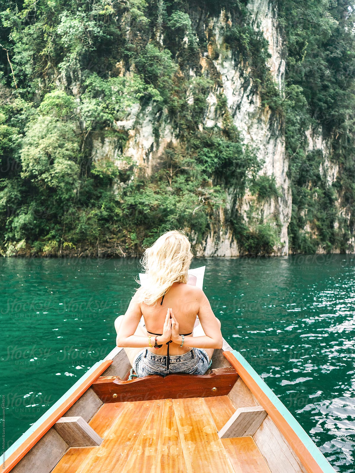 Woman posing on boat in tropics
