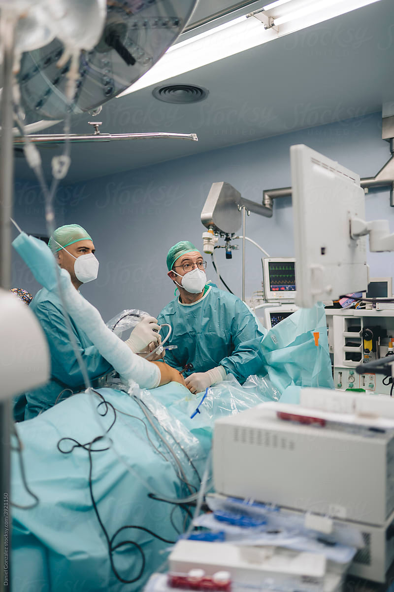 Surgeons in operating room with monitor