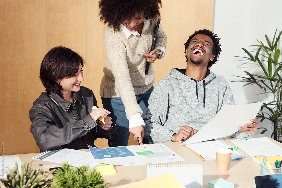 Joyful Teamwork and Laughter in a Collaborative Workspace