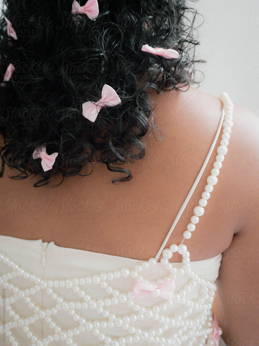 Many Pink Bows in Curly Hair with Pearl Top