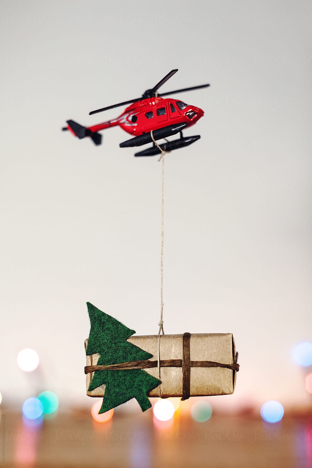 Christmas gift hanging on a red toy helicopter.