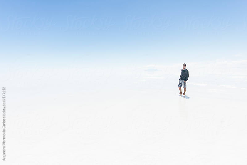 Young man in salt flat of Uyuni, Bolivia. Adventure travel