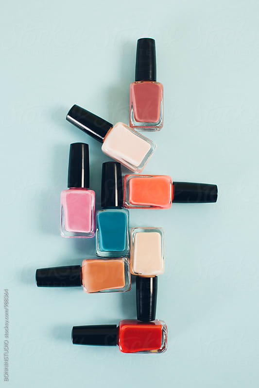Pastel colored nail polish bottles from above.