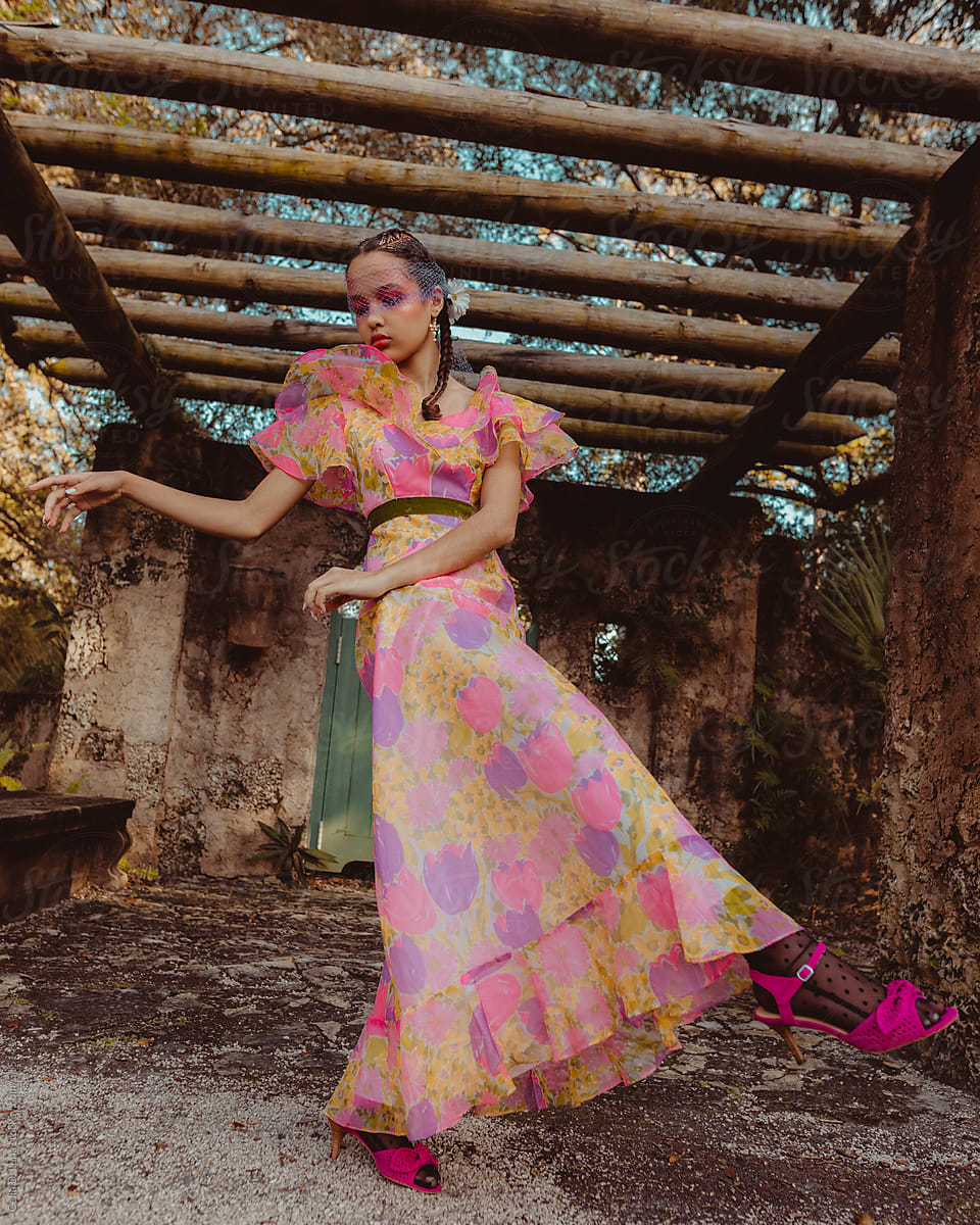 Young afro latinx woman dancing in a pergola