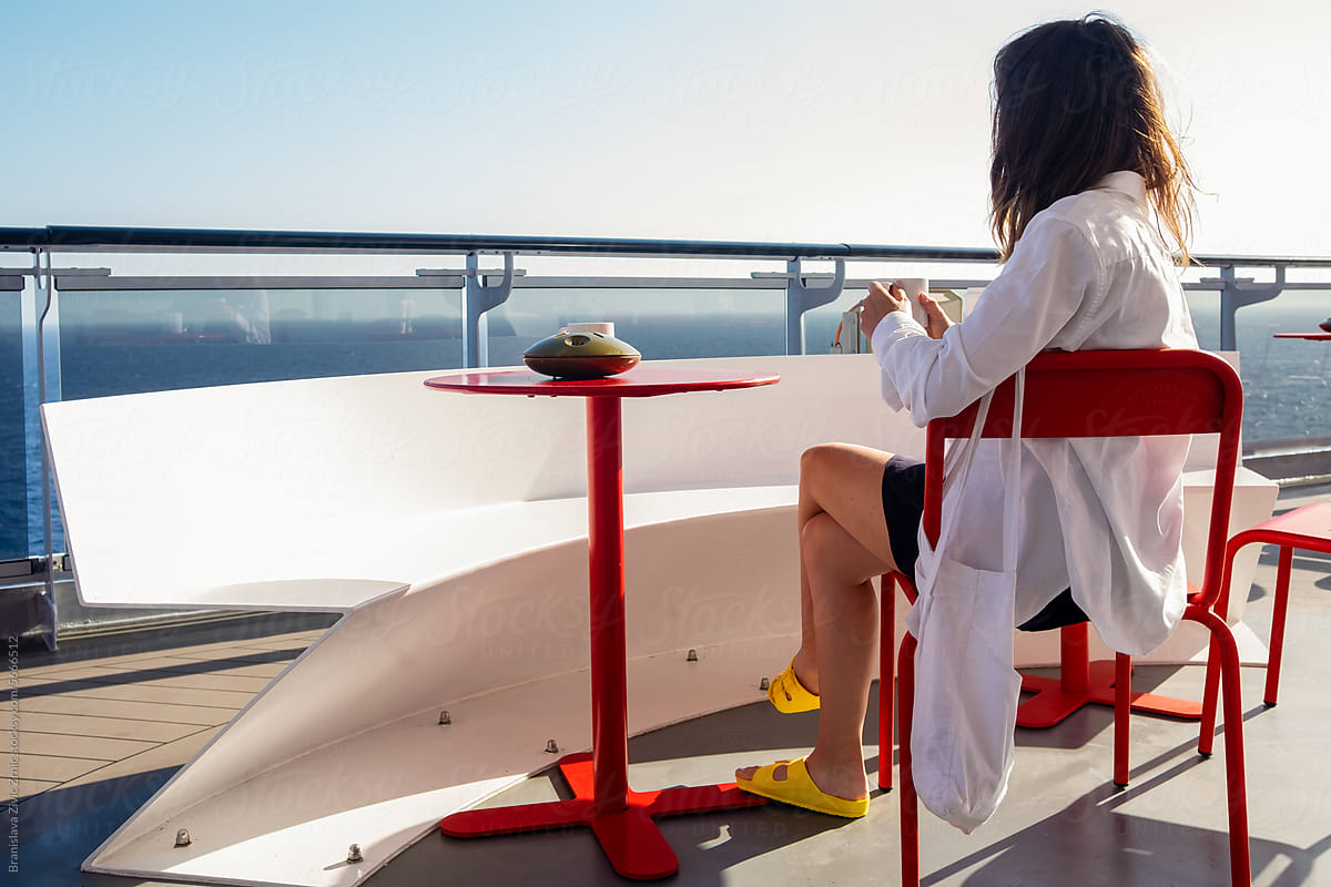 A woman looking at the ocean on the terrace of a cruise ship