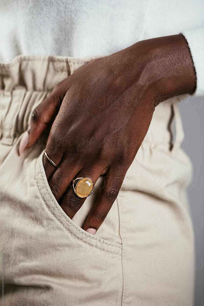 Crop model with ring putting hand in pocket