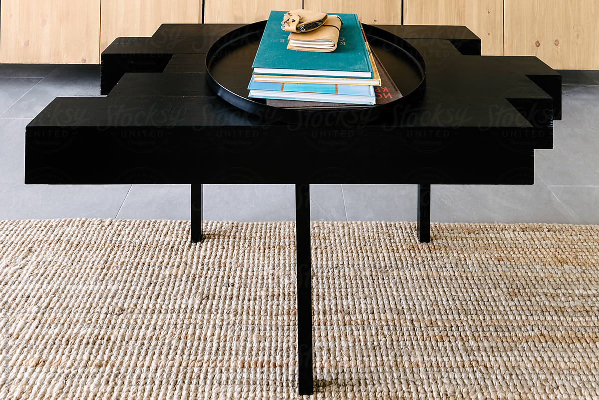 Hand made black center table with books over it