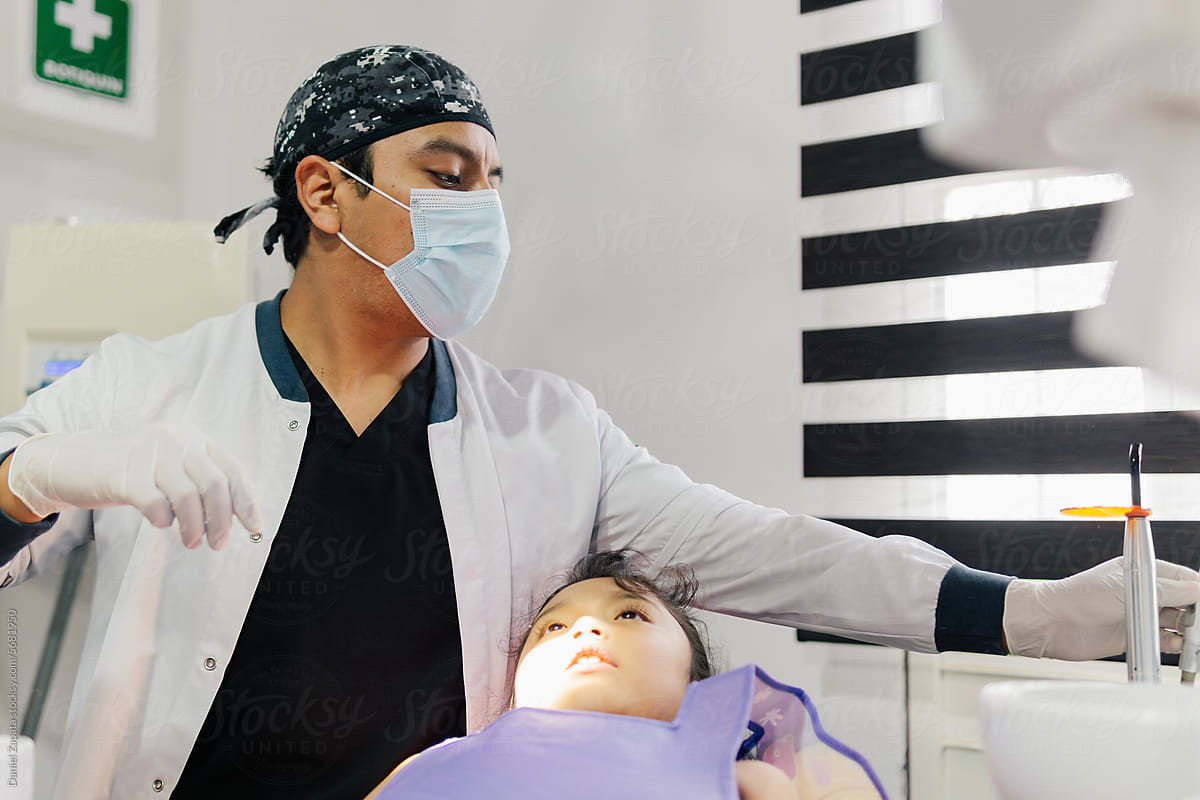 Little girl at the dentist receiving dental treatment.