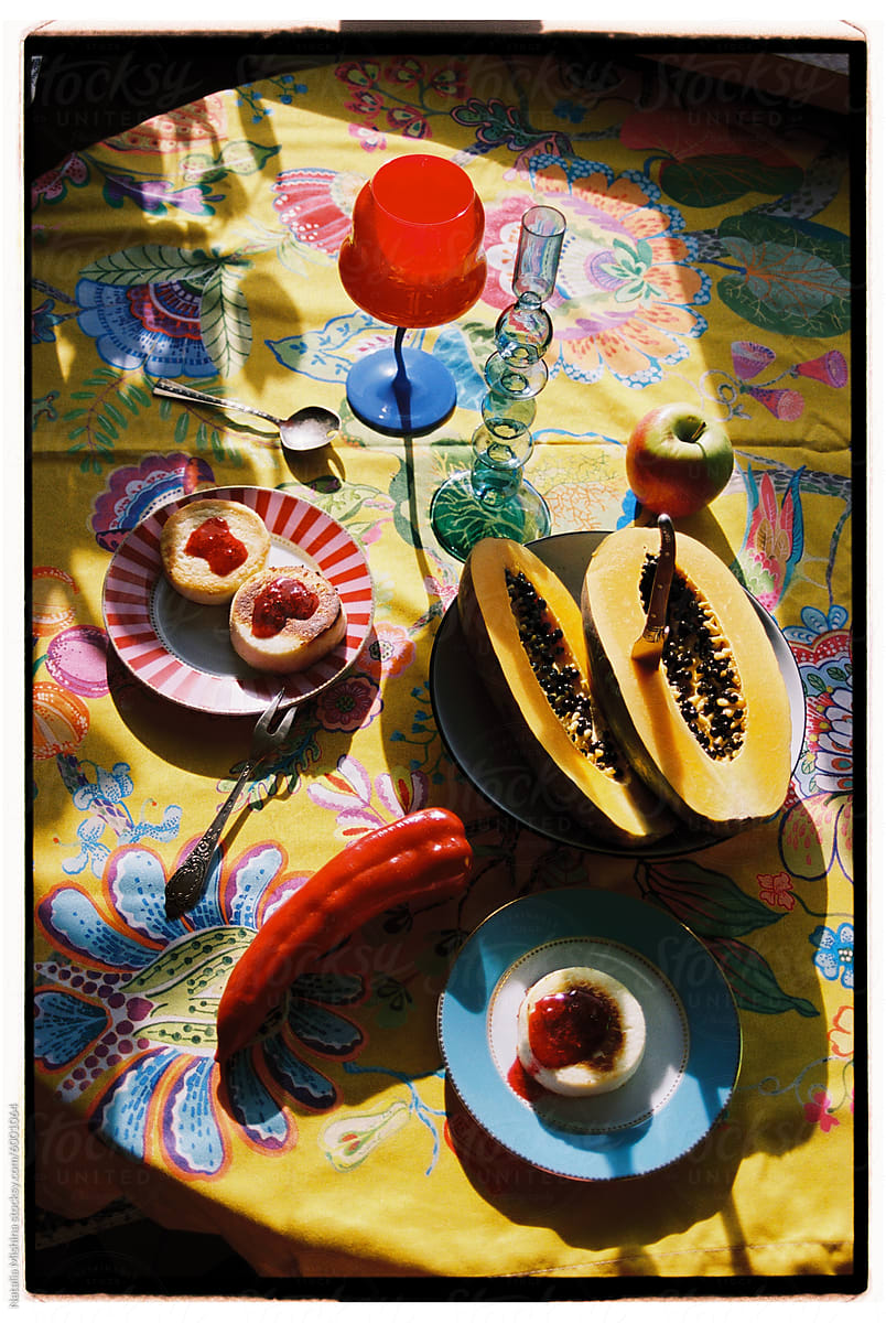 A bright still life on a yellow tablecloth.