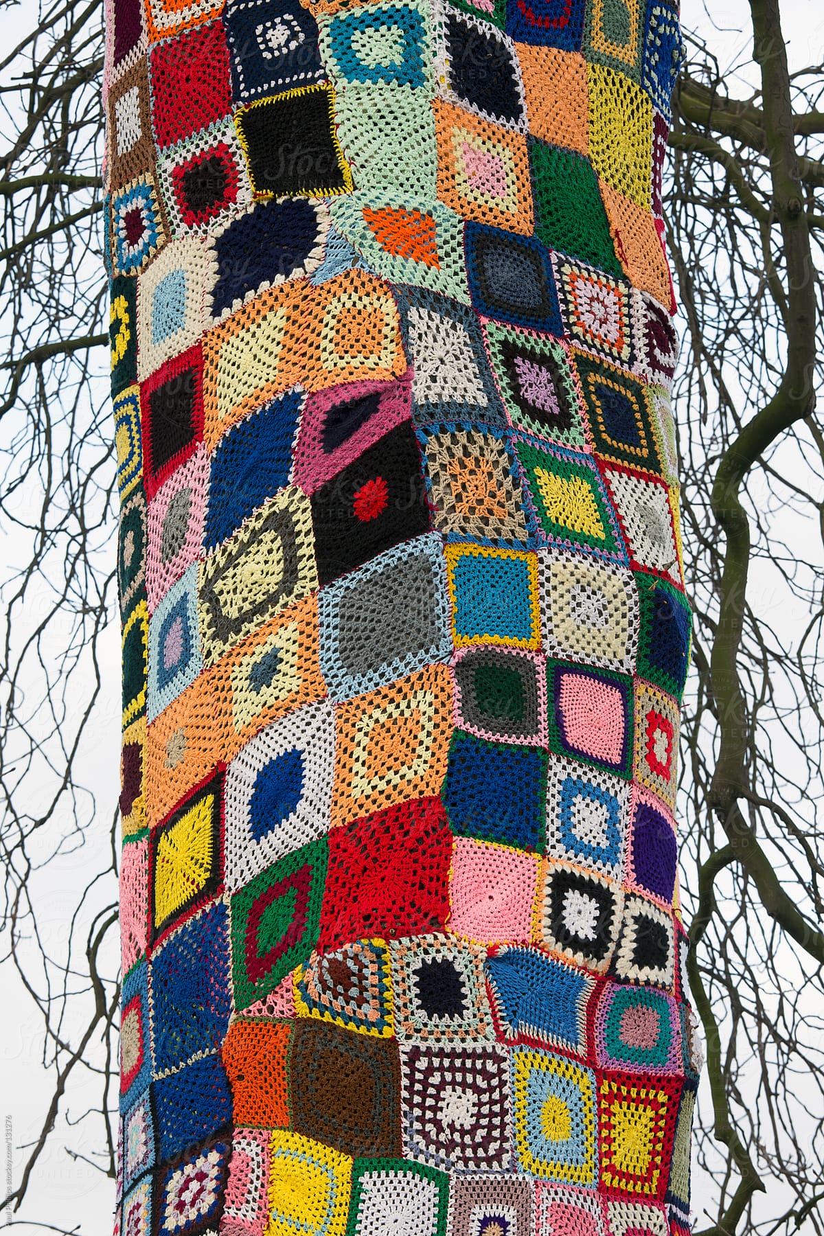 1,500 crocheted  squares draped around a large tree. Known as a \