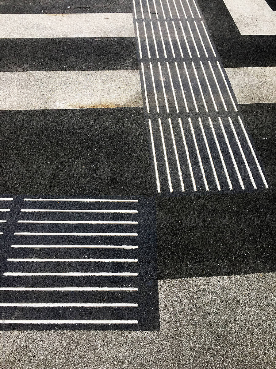 lines on asphalt road with markings for blind people