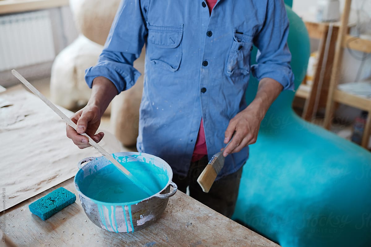 Craftsman painting in workshop
