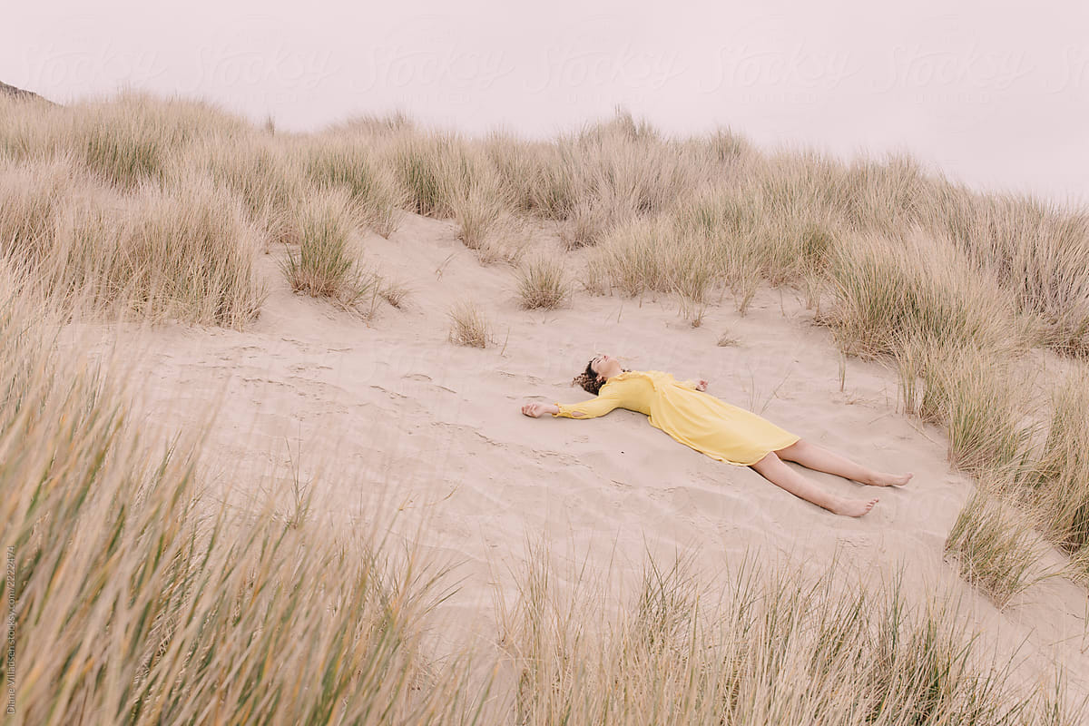 Girl in yellow dress on dunes