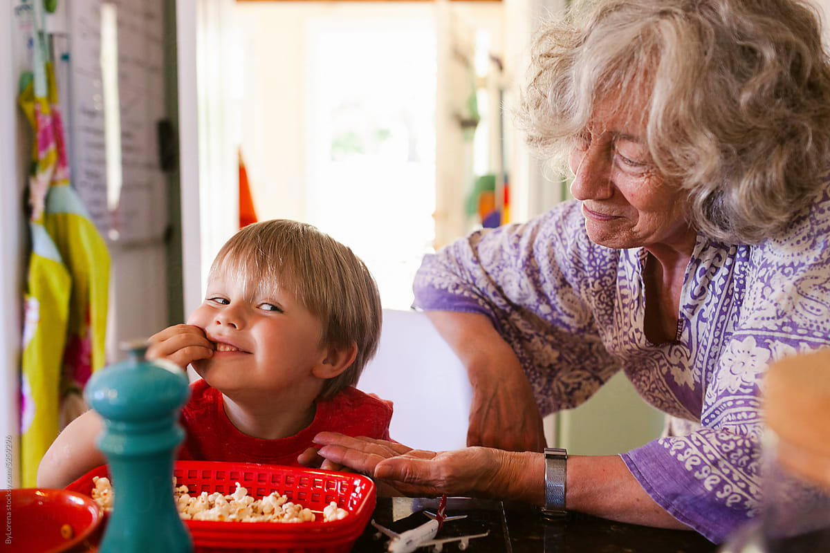 Little boy eating popcorn at grandma?s house