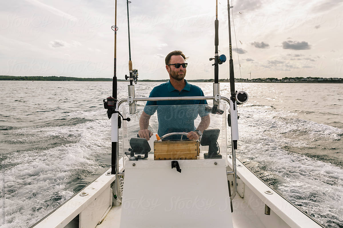 Outdoor Active Lifestyle of  man Driving Boat in Fall
