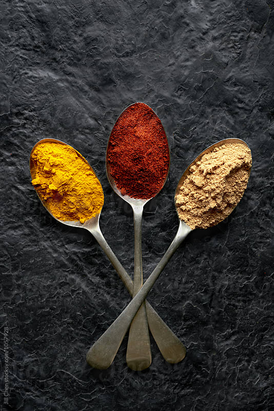 Vibrant spices on textured background