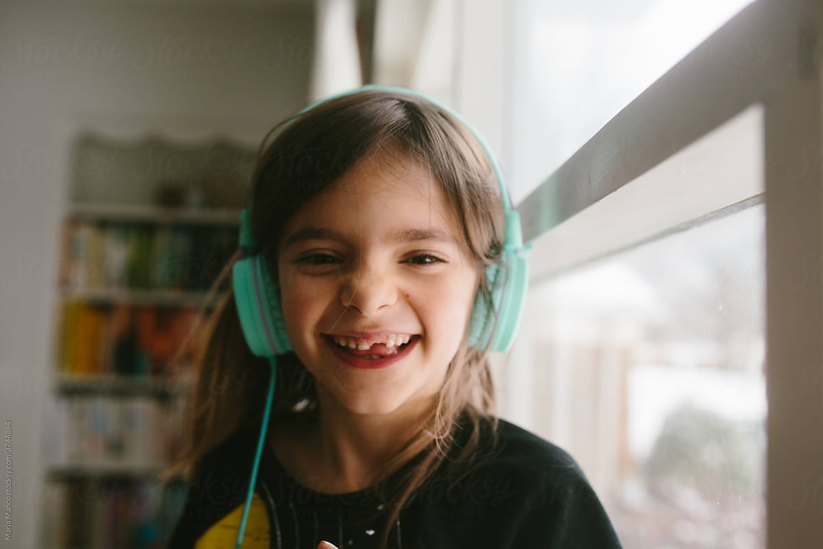 Young girl laughs with headphones