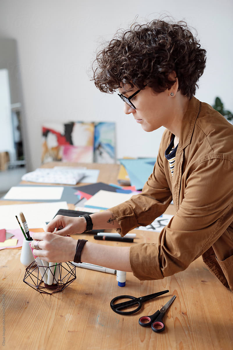 Curly woman creating workspace