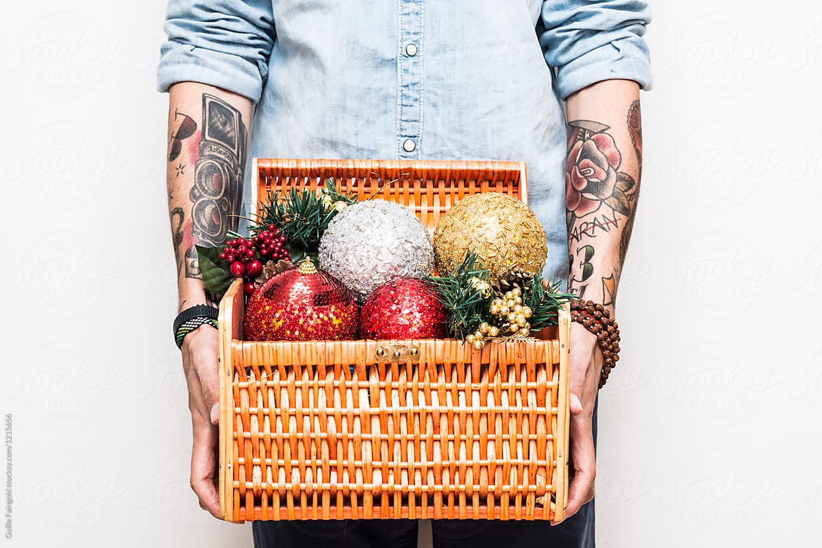 Man holding wattled basket full of Christmas