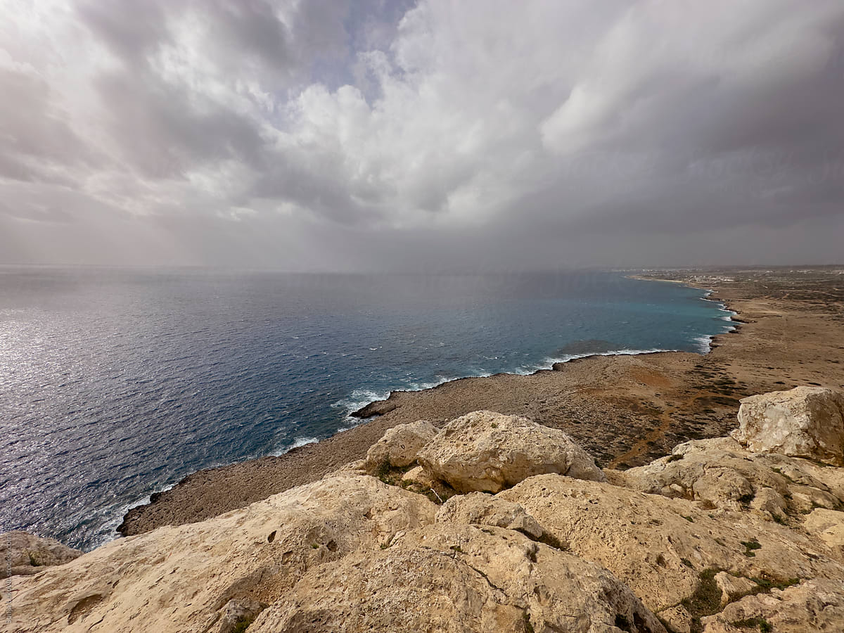 Gloomy weather sky, sea and rocky shore landscape