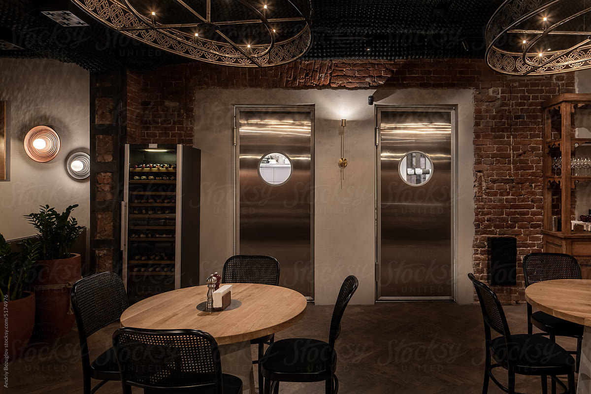 Illuminated restaurant in loft style with shabby brick walls