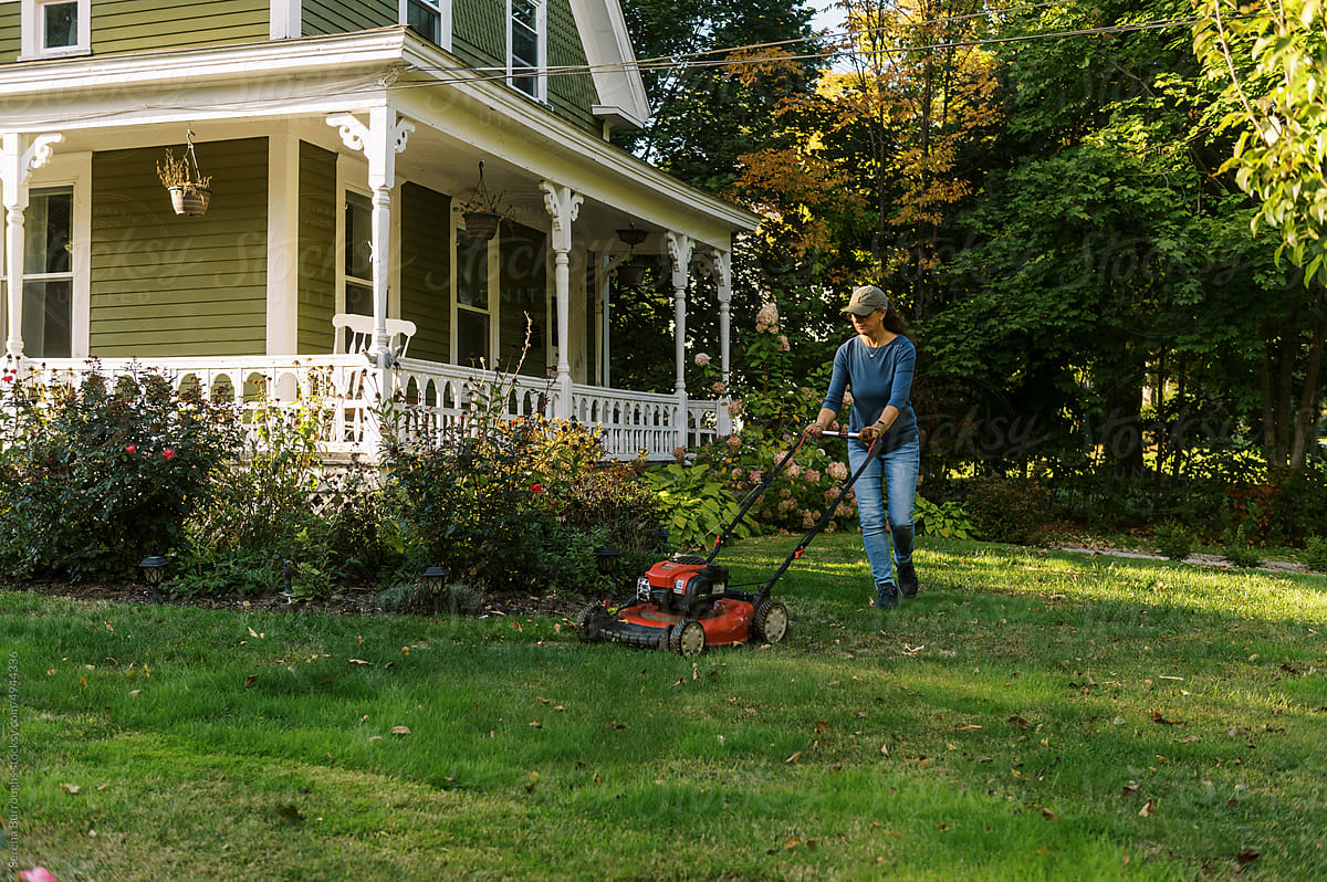 woman mowing the yard