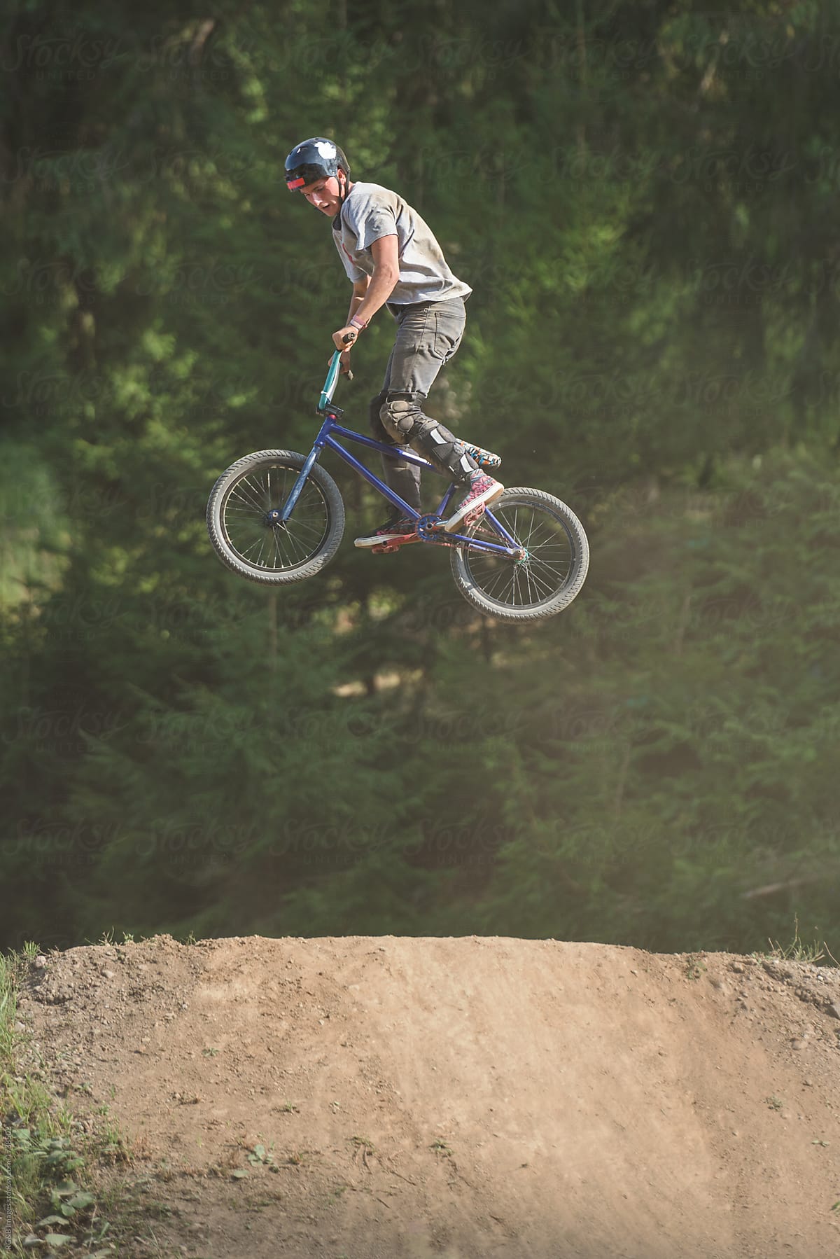 Male teenager catching air with BMX