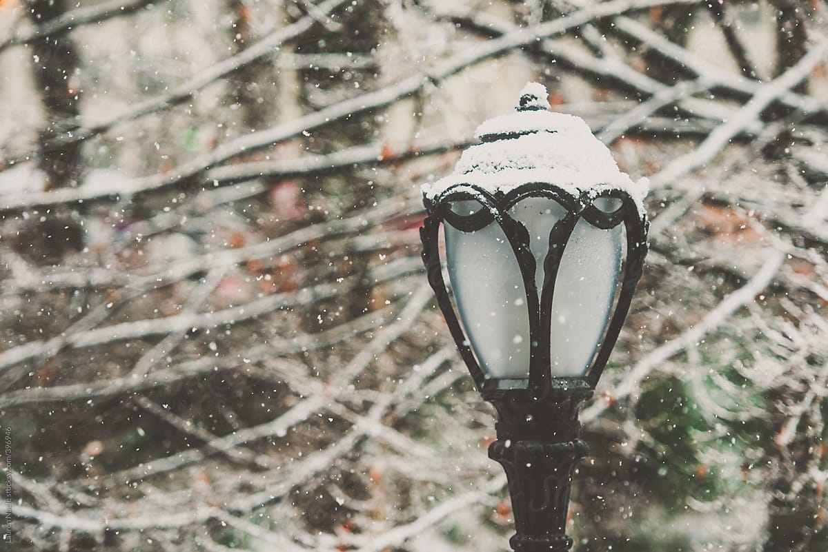 Snow falling around a street lamp