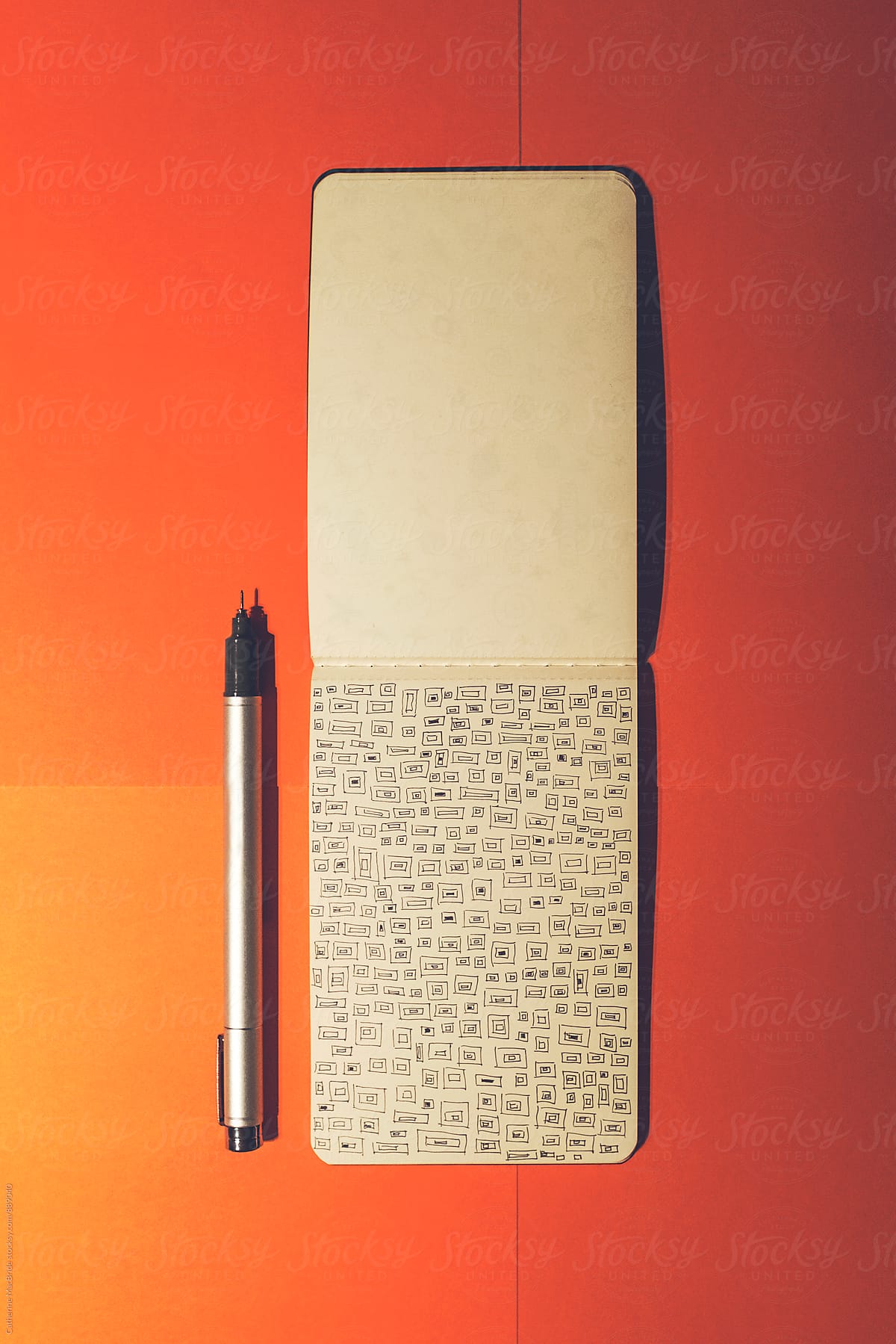 Squared doodle in notebook on orange...