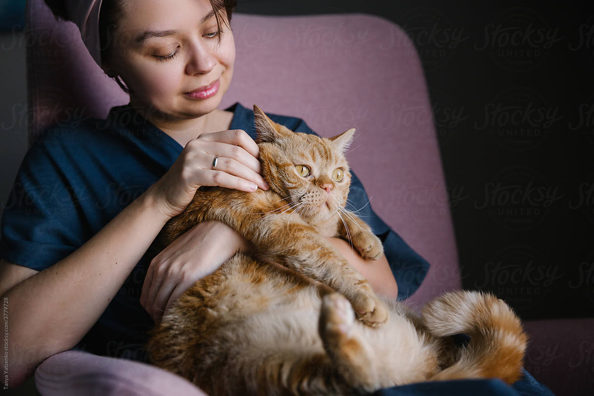 A woman holding a cat