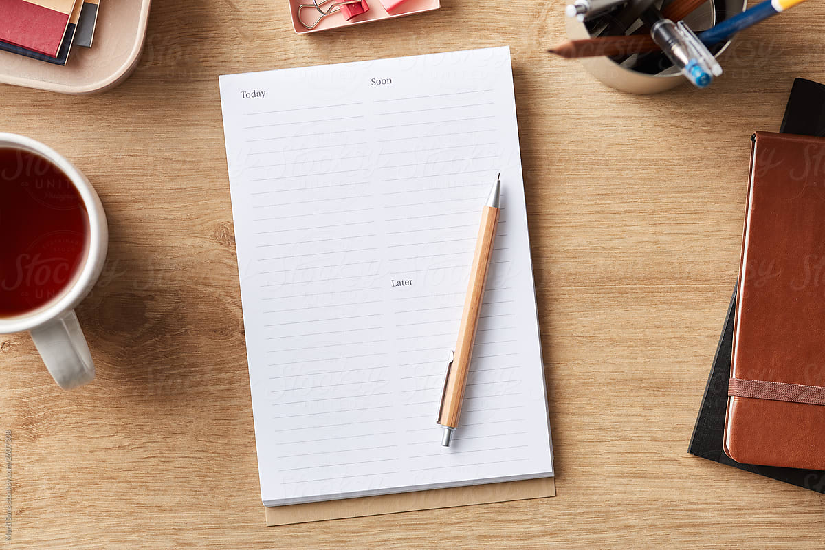 Office supplies with notepad and tea cup