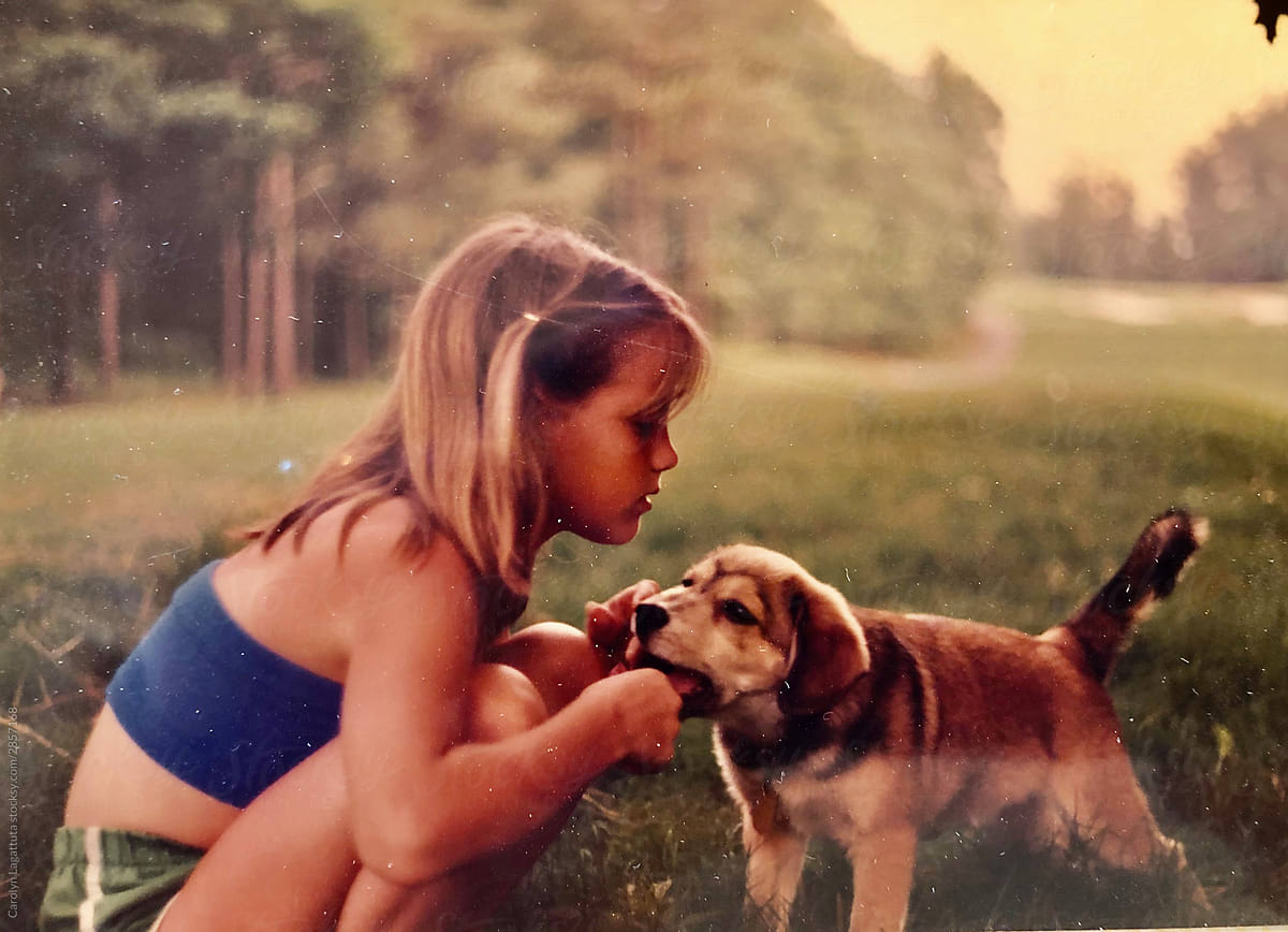 Film photo of a young girl and her puppy