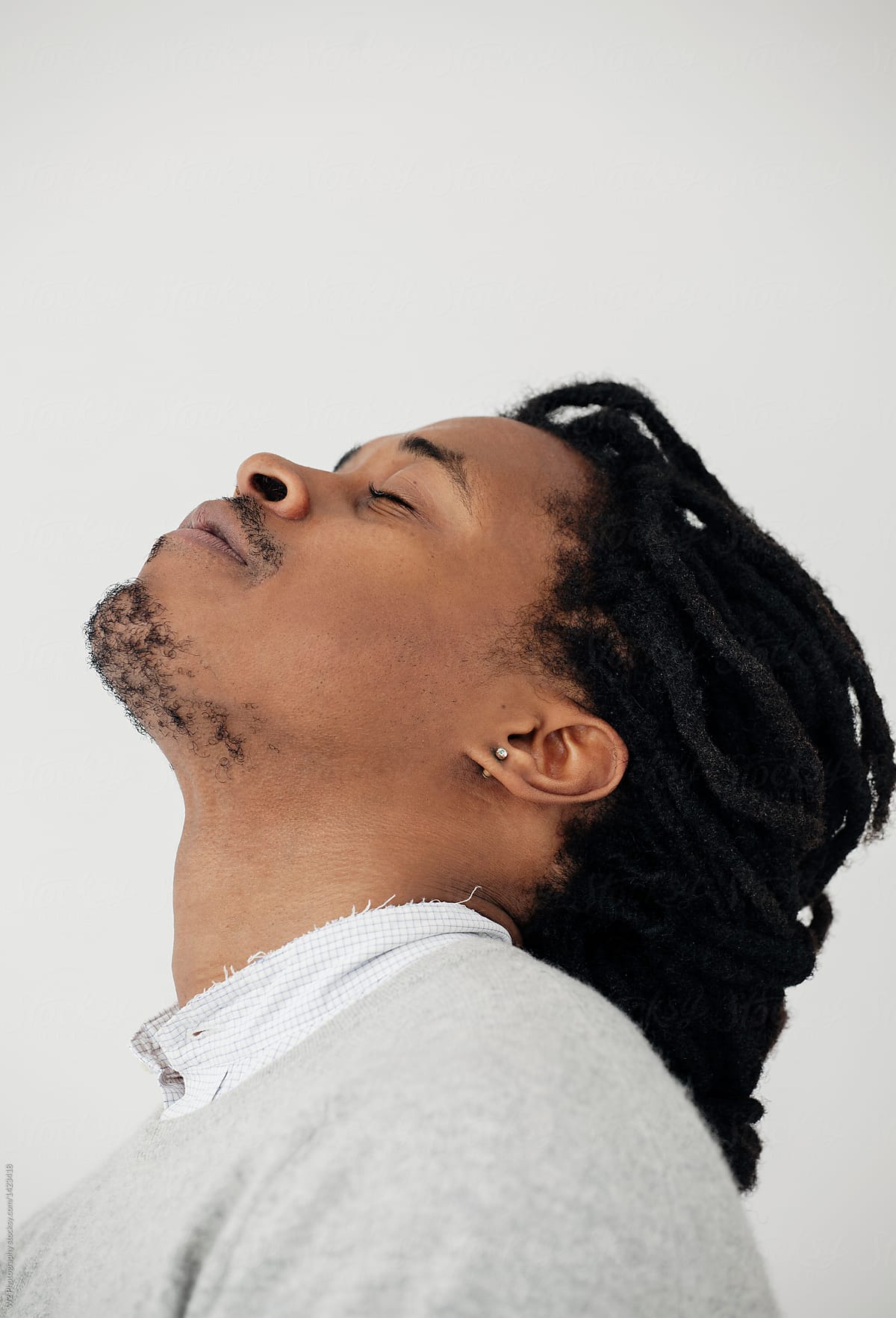Black man with head up and closed eyes.