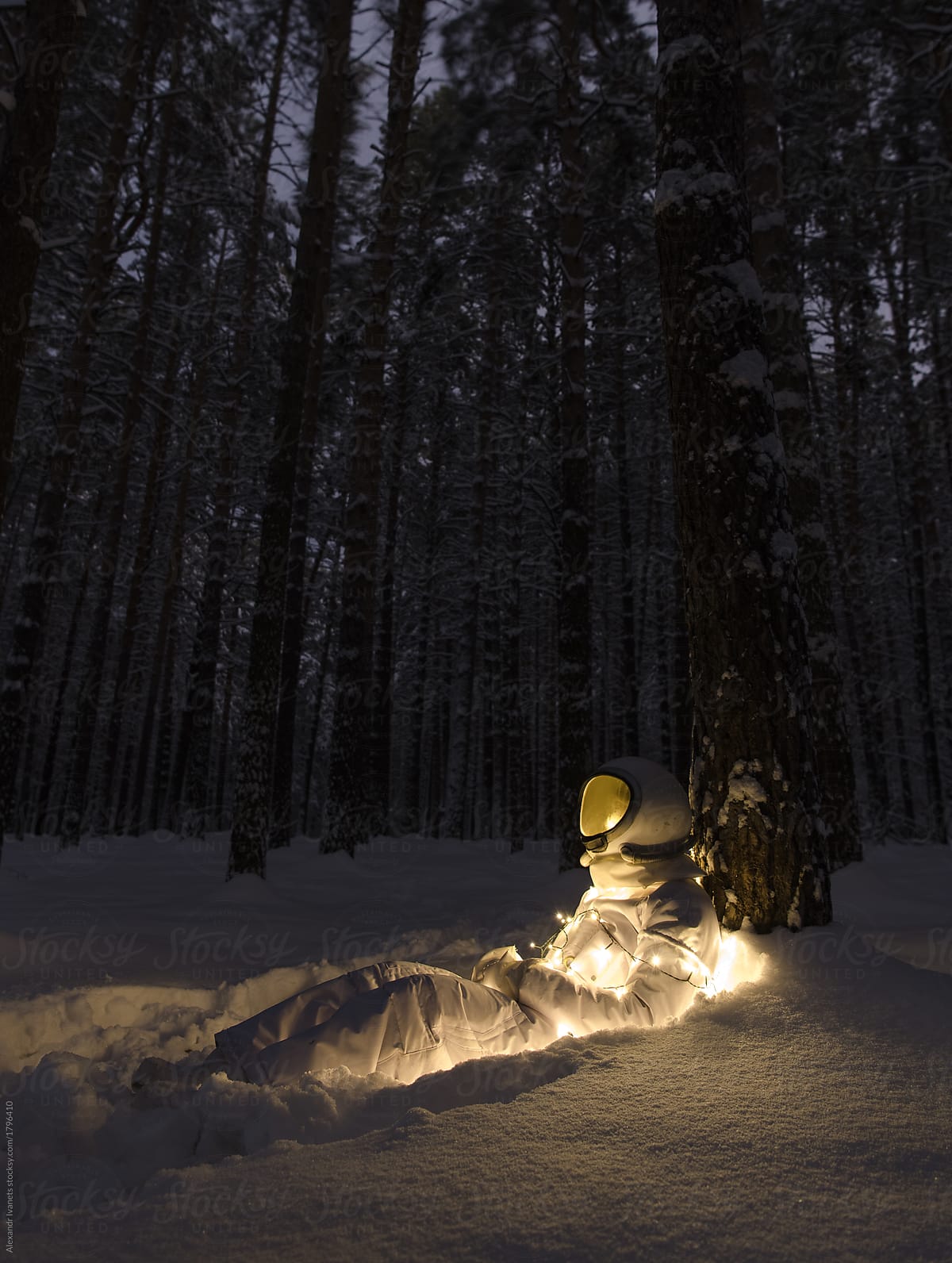 Astronaut in garland in snow