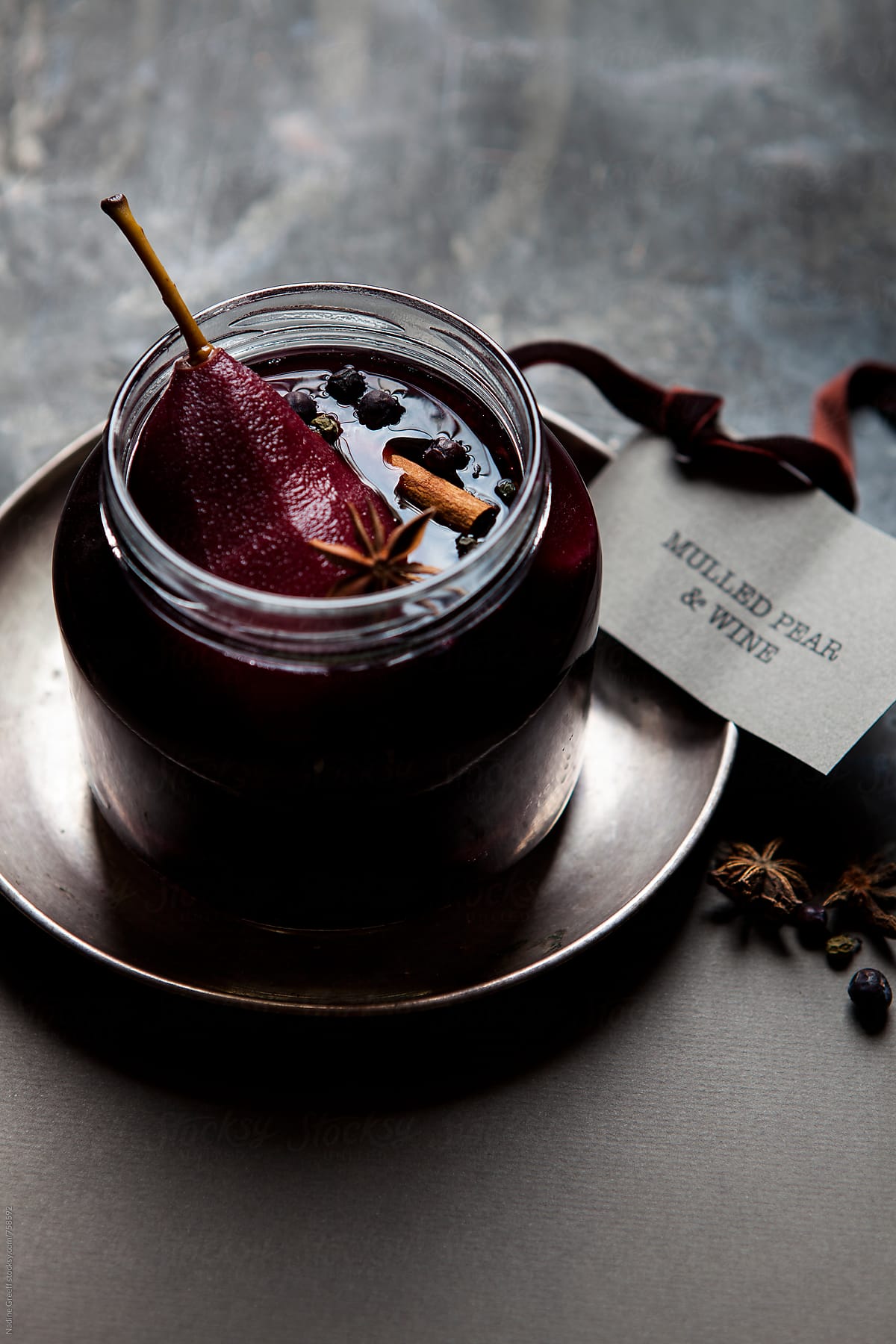 Poached pears in mulled red wine with juniper berries, cinnamon and star anise