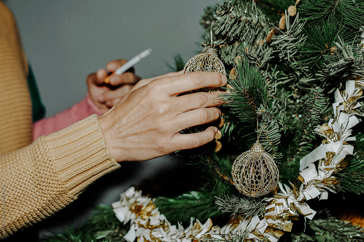 cigarette christmas tree Man Decorates The Christmas Tree While Is Smoking A Cigarette