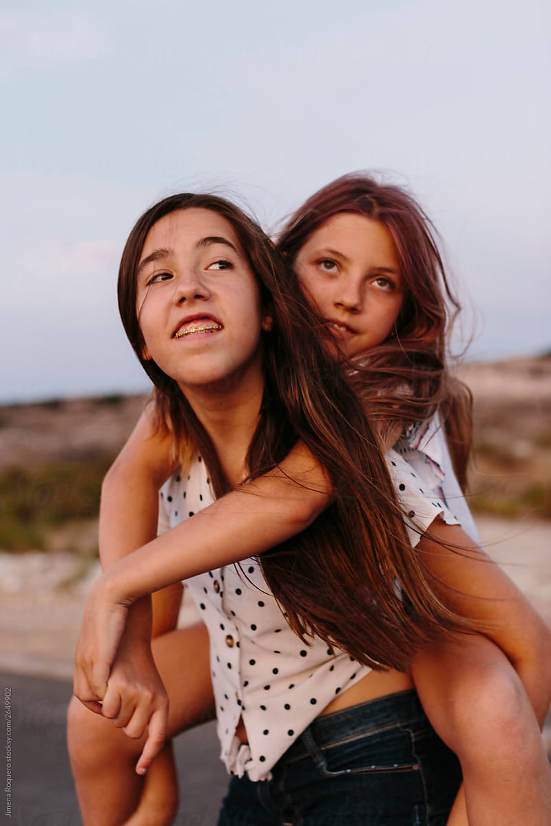 Two young girls looking at sunset.