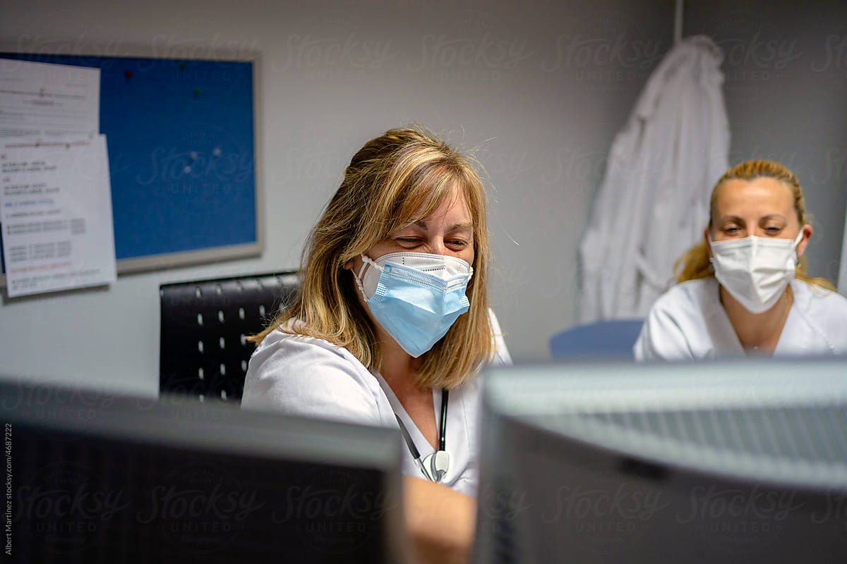 Female doctor discussing data with nurse