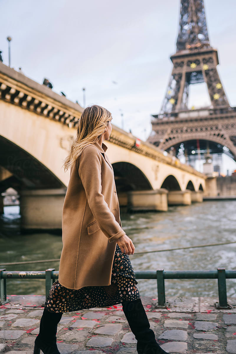Unrecognizable woman walking near Eiffel Tower