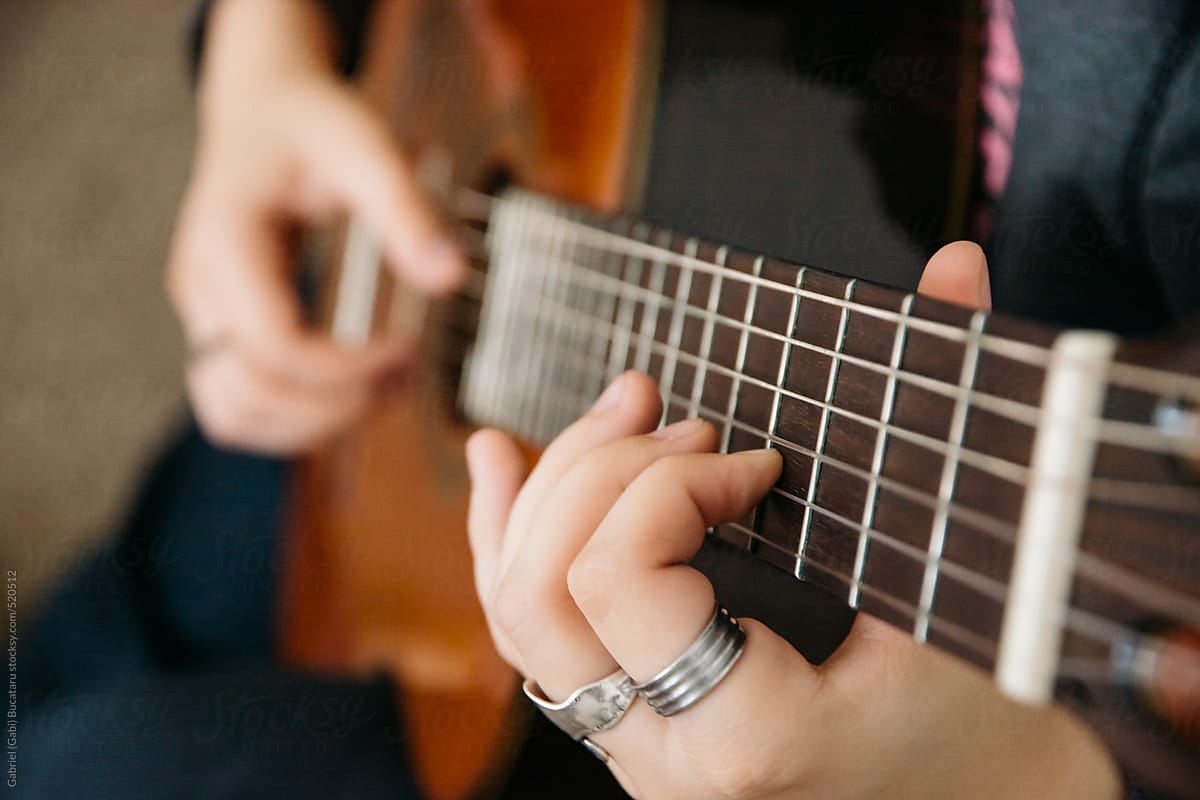 Hands of a young girl playing Spanish guitar