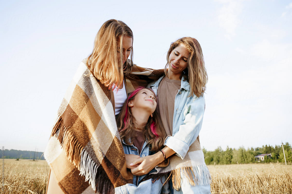 LGBT family with a daughter in wheat field